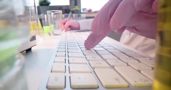 Doctor Hands in Gloves are Typing on Keyboard Closeup