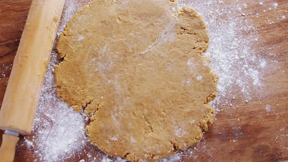 Flattened dough on a wooden table