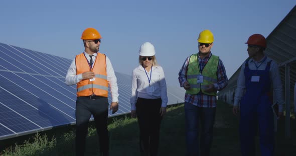 Electrical Workers Walking in a Solar Farm