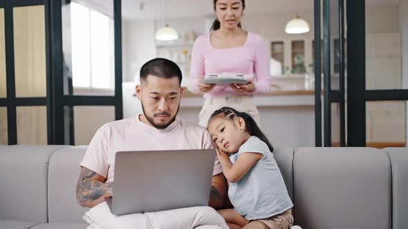 Asian Mother Carries Cupcakes Giving to Father and Daughter