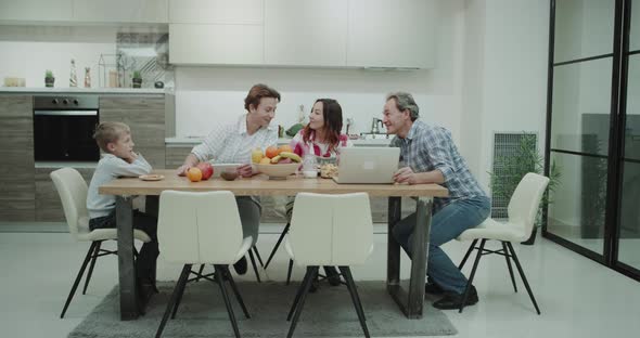 In a Modern Kitchen a Mature Family Spending Time