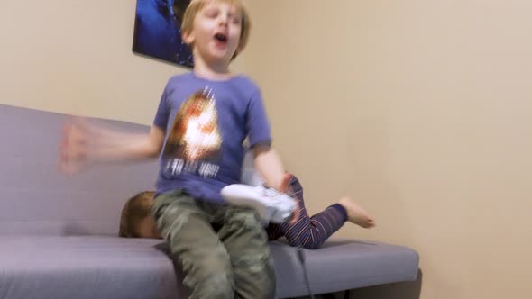 Excited little boy playing video games.