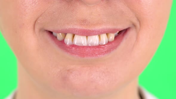 Female Smiling Widely with Teeth, Close-up. Green Screen