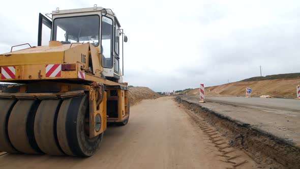 Road Roller Compacts Sand to Pave the Road