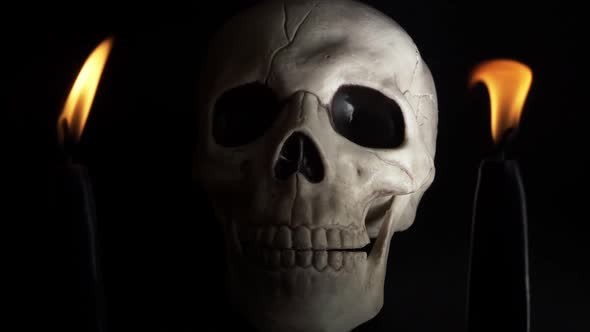 Time lapse of human skull with candles