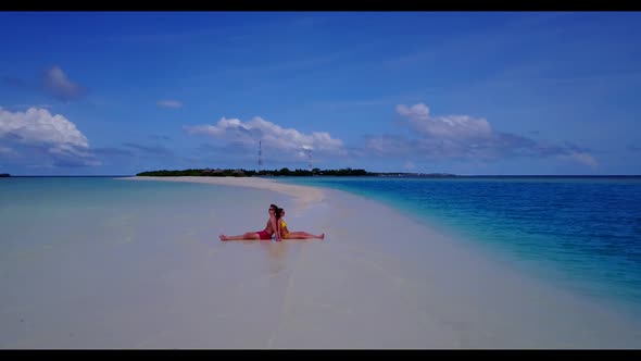 Teenage lovers relax on tranquil island beach lifestyle by transparent ocean and white sandy backgro