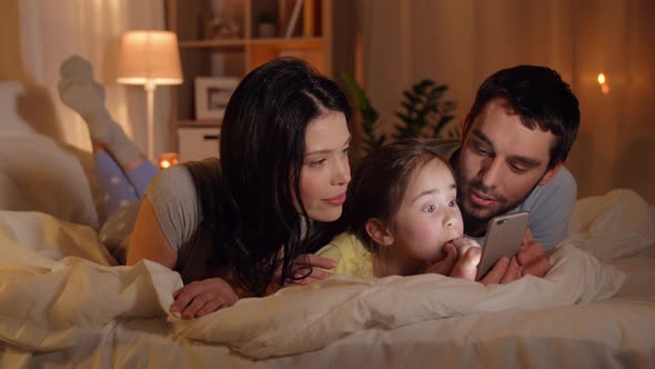 Happy Family with Smartphone in Bed at Home 17