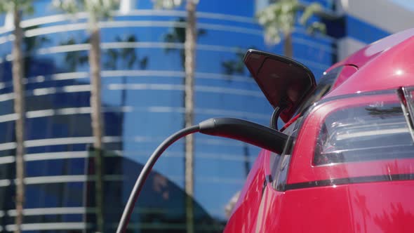 Handsome Man Opening Door Getting Out Car to Pull Charging Cord From Vehicle 6K