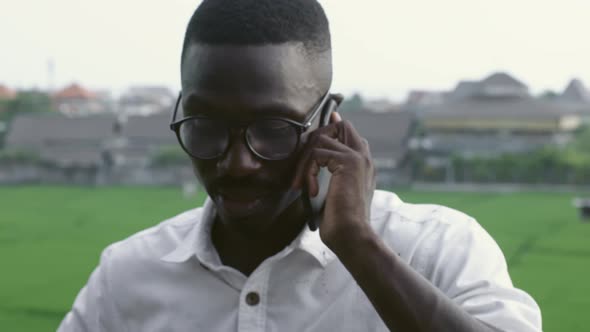 Young Black Man Talking on the Phone