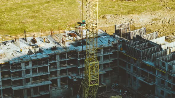 Construction Workers and Tower Crane Work on Building Area