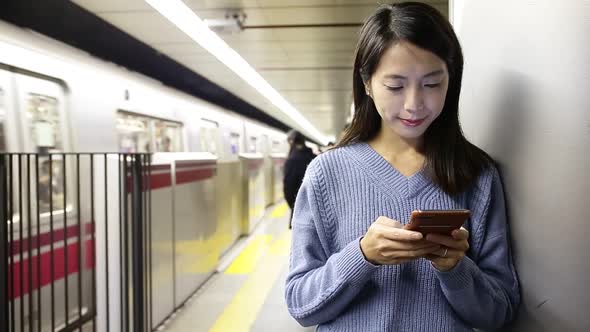 Woman use of smartphone at subway station
