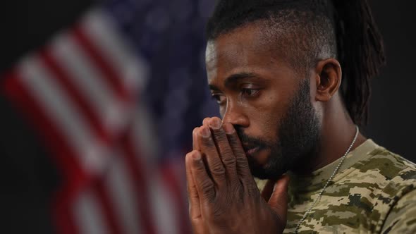 Closeup Side View of Sad African American Military Man Thinking Holding Hands at Face