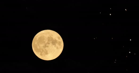 A firework in front of the Super full moon in the french sky