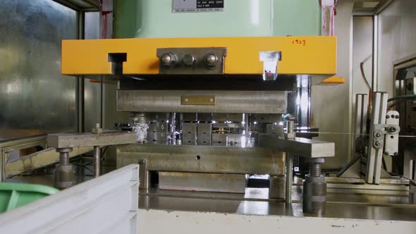 A large industrial punch press forming sheet metal parts