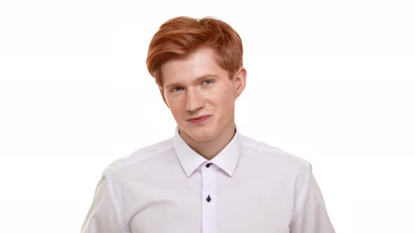 Handsome Young Caucasian Man with Red Hair Seductively Looking at Camera Flirting on White