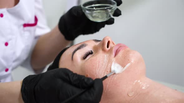 Woman Getting Emulsion on Face in Wellness Spa