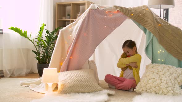 Little Girl with Teddy Bear in Kids Tent at Home