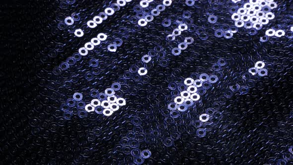 Shiny blue  sequin fabric reflecting light 4K 2160p UltraHD tilt footage - Slow tilting over blue se