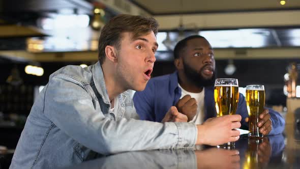 Excited Male Friends Clinking Beer Glasses Supporting National Team, Rooting