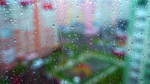 Window at rainy day on blur city background