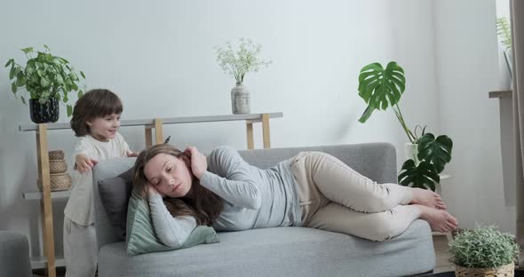 Tired Woman Lying on Couch Relaxing Cosiness Home Interior