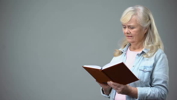 Senior Woman Having Troubles With Reading Book, Poor Vision, Eyesight Problems