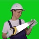 Woman Builder in Blue Overalls and White Hard Hat Helmet with Hand Saw - VideoHive Item for Sale