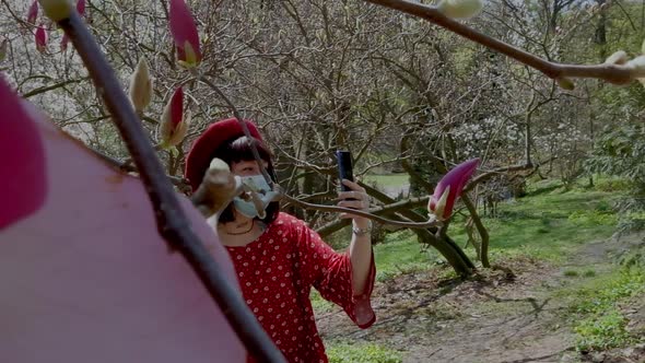 European Girl is Talking Facetime in Protective Face Mask in Outdoors