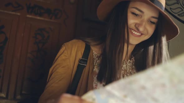 Smiling Woman Reading a Map