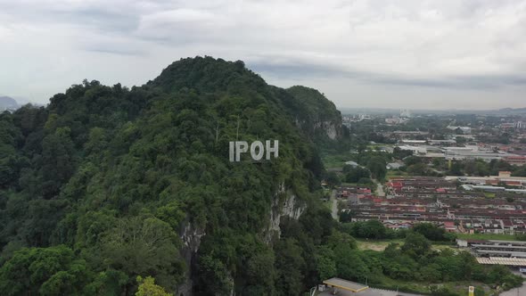 Panoramic aerial shot capturing busy highway traffics with iconic landmark of IPOH signage on top of