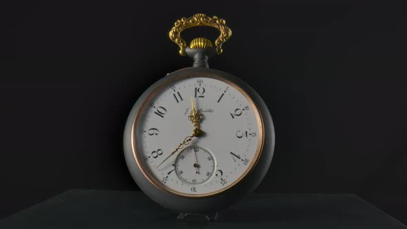 Silver Vintage Pocket Watch with Running Gold Hands in Timelapse Video