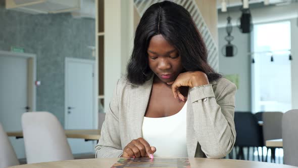 AfricanAmerican Businesswoman Chooses Dishes in Cafe