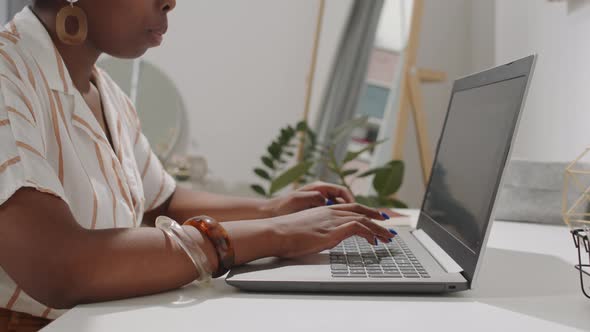 Midsection of Black Woman Typing on Laptop