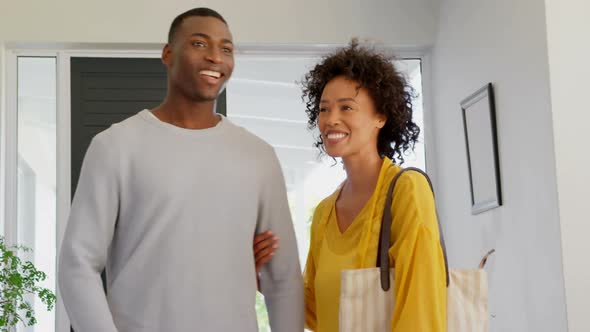 Front view of happy black couple standing in their new house 4k