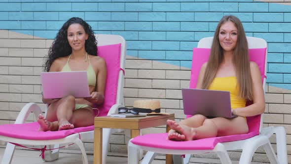 Successful Young Multiracial Female Caucasian Hispanic Freelance Bloggers Work By Computer Remotely