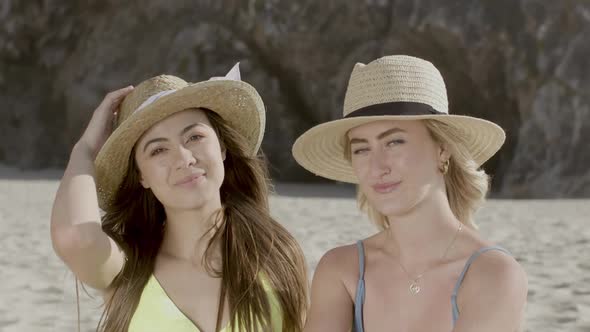 Portrait of Girls Sitting on Beach and Looking at Camera