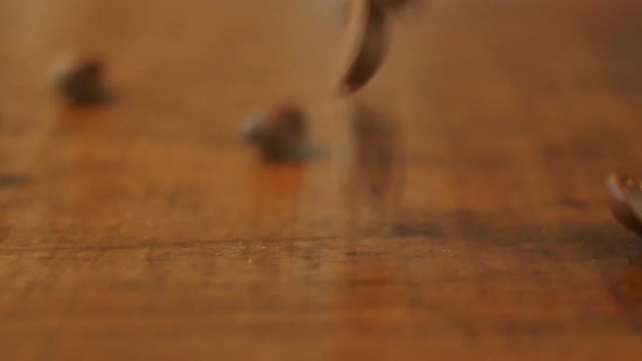 Coffee Beans Are Falling on the Wooden Table