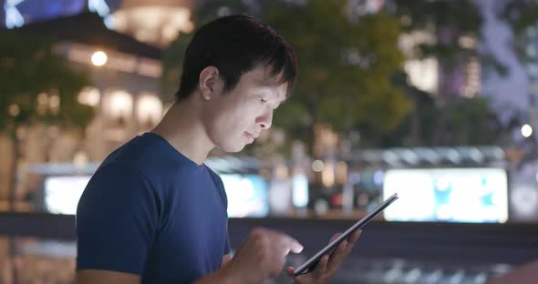 Man Use of Tablet Computer at Night