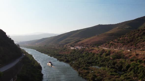 Boat Traveling on River Douro at Sunset