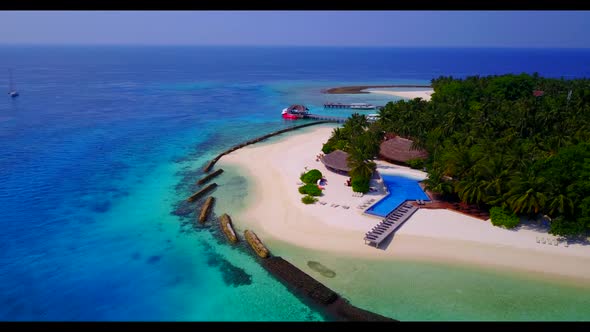 Aerial flying over nature of relaxing coast beach holiday by aqua blue sea and bright sand backgroun