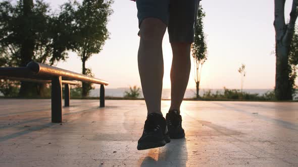 Fit Handsome Middle Aged Man Walking on Sports Ground with Sea Background Close Up Shot