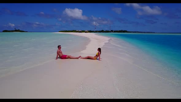 Man and lady posing on relaxing shore beach journey by blue green ocean and bright sandy background 