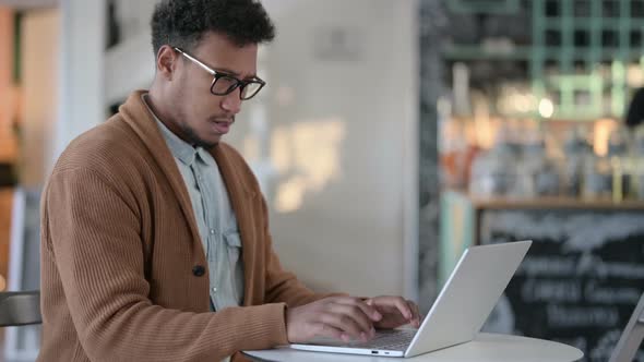 No Gesture By African Man with Laptop in Cafe