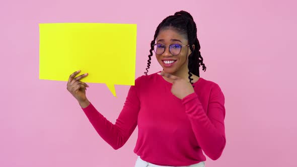 Young African American Girl in Pink Clothes Stands with Posters for Expression on a Solid Pink