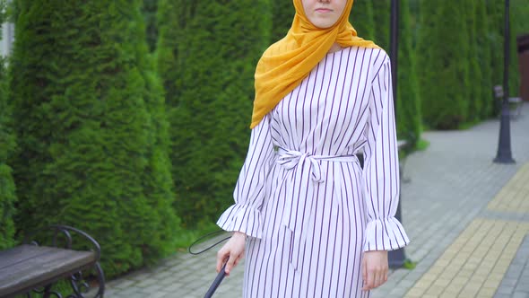 Young Attractive Muslim Woman Visually Impaired with a Walking Cane in the Park Close Up