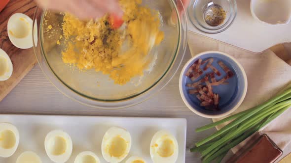 Preparing deviled eggs with organic eggs for appetizer. Step by step recipe.