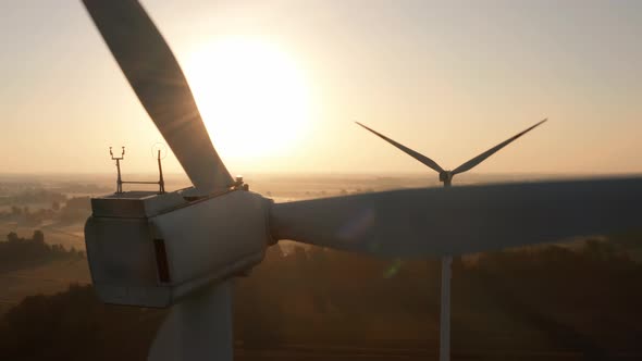 Drone Shot at a Windmill Farm in a Wheat Field at Sunset