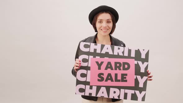 Black Friday Video Footage - A Woman Holding A Charity Yard Sale Poster