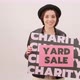 Black Friday Video Footage - A Woman Holding A Charity Yard Sale Poster - VideoHive Item for Sale