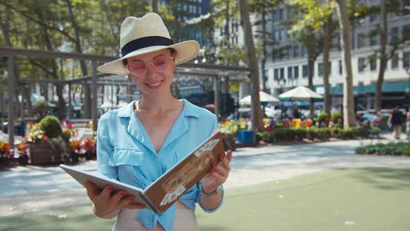 Attractive girl with a travel book in a cafe